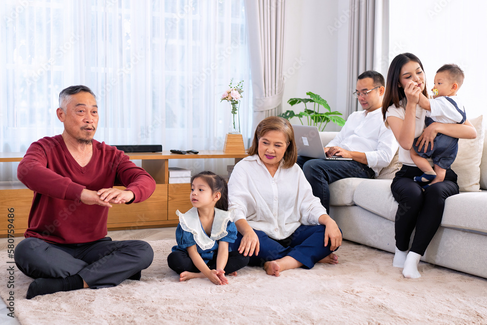 The family have fun relax engaged in fitness yoga at home using online instruction from laptop The family have fun relax engaged in fitness yoga at home using online instruction from laptop