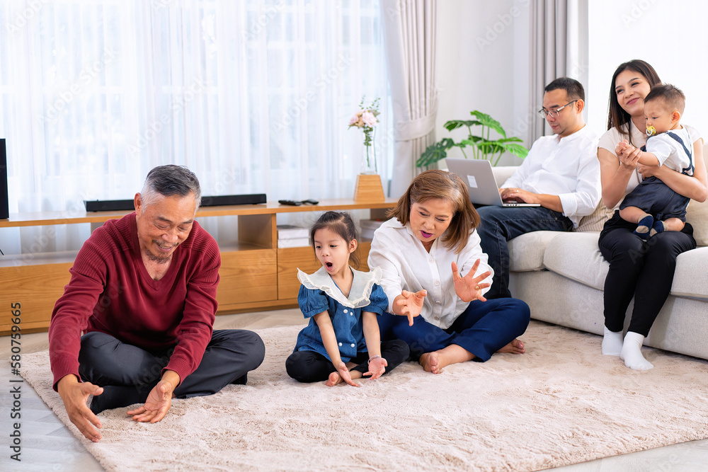 The family have fun relax engaged in fitness yoga at home using online instruction from laptop The family have fun relax engaged in fitness yoga at home using online instruction from laptop