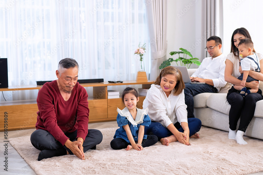 The family have fun relax engaged in fitness yoga at home using online instruction from laptop The family have fun relax engaged in fitness yoga at home using online instruction from laptop
