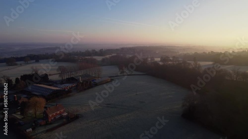 Sunrise over a frosty rural England in winter