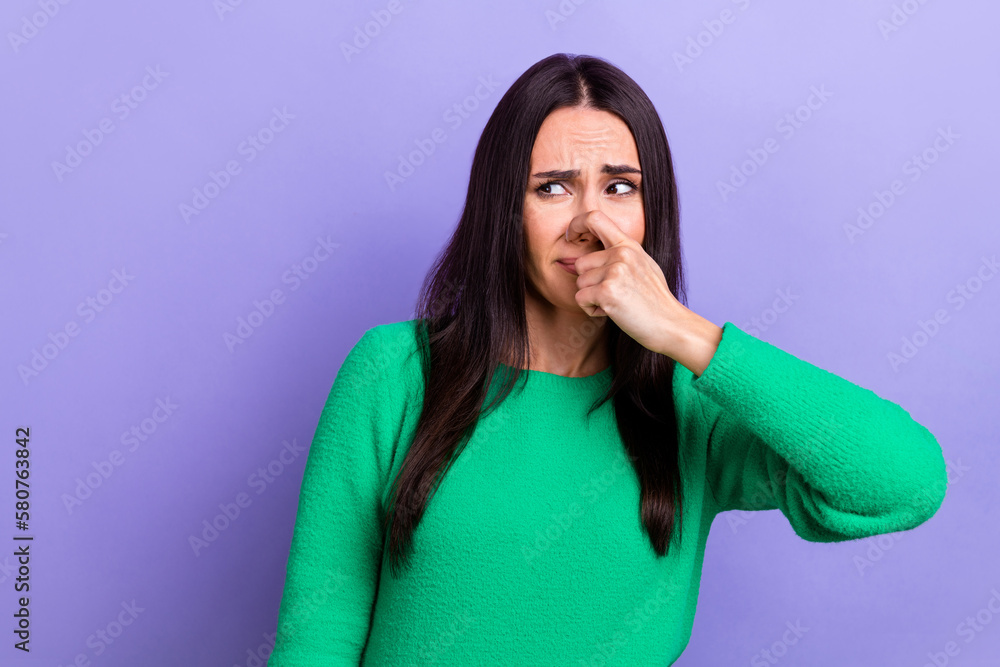 Young woman photo closing her nose look side hear unpleasant smell stink stinky smelly spoiled food isolated violet color background Young woman photo closing her nose look side hear unpleasant smell stink stinky smelly spoiled food isolated violet color background