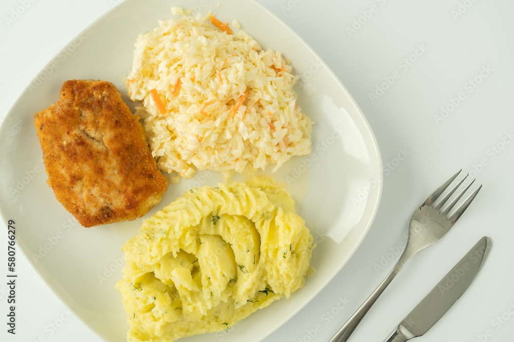 Kotlet schabowy, Polish breaded cutlet, served with mashed potatoes and coleslaw salad. Traditional food in Poland. Kotlet schabowy, Polish breaded cutlet, served with mashed potatoes and coleslaw salad. Traditional food in Poland.