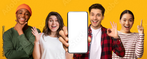 Картината върху платно Smiling multiethnic people show smartphone with empty screen make ok hand gestur