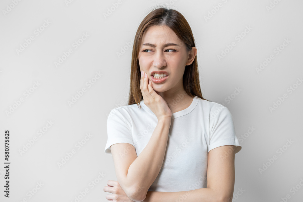 Face expression suffering from sensitive teeth and cold, asian young woman, girl feeling hurt, pain touching cheek, mouth with hand. Toothache molar tooth, dental problem isolated on white background. Face expression suffering from sensitive teeth and cold, asian young woman, girl feeling hurt, pain touching cheek, mouth with hand. Toothache molar tooth, dental problem isolated on white background.