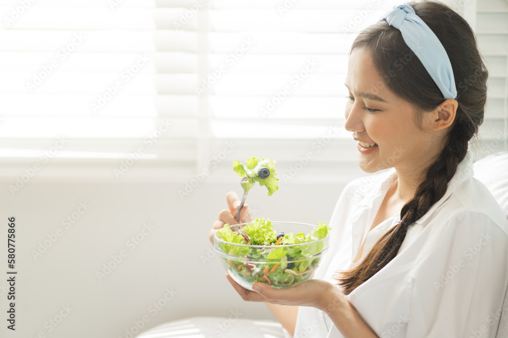 Diet, Dieting pretty attractive asian young woman, girl use fork at lettuce on mix vegetables, green salad bowl, eat food is low fat to good body. Nutritionist female, Weight loss for healthy person. Diet, Dieting pretty attractive asian young woman, girl use fork at lettuce on mix vegetables, green salad bowl, eat food is low fat to good body. Nutritionist female, Weight loss for healthy person.