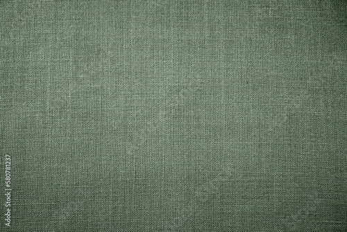 green background fabric texture. A piece of woolen cloth is neatly laid out on the surface. Weave and textile texture. Dress fabric or for kitchen needs, tablecloth or curtains, close-up. Dash