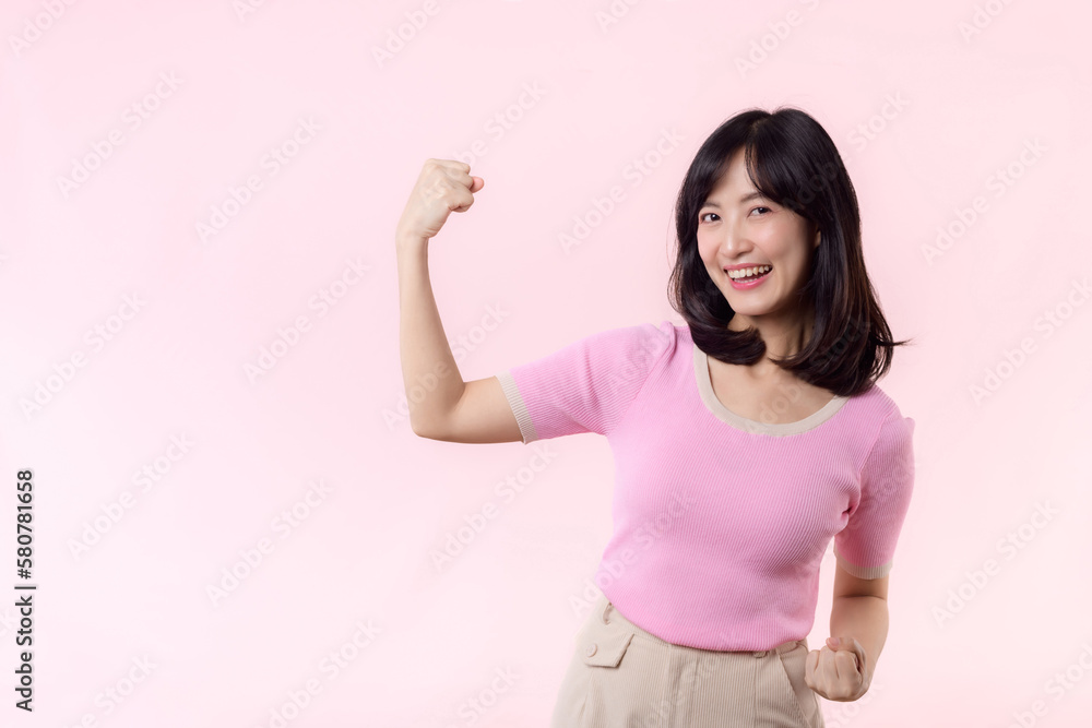 Portrait young asian woman proud and confident showing strong muscle strength arms flexed posing, feels about her success achievement. Women empowerment, equality, healthy strength and courage concept Portrait young asian woman proud and confident showing strong muscle strength arms flexed posing, feels about her success achievement. Women empowerment, equality, healthy strength and courage concept