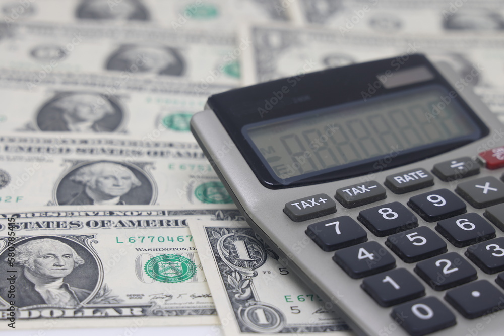 Money dollars and calculator, economy concept, money distribution. Euro. The crisis after the covid-19 pandemic. The dollar is falling or rising. Money dollars and calculator, economy concept, money distribution. Euro. The crisis after the covid-19 pandemic. The dollar is falling or rising.