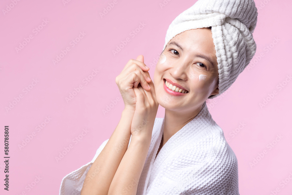 Young asian woman applying facial skincare face cream, cosmetic moisturiser on healthy natural skin make up face. Portrait glowing smile girl person model with care beauty product, spa, cosmetology.