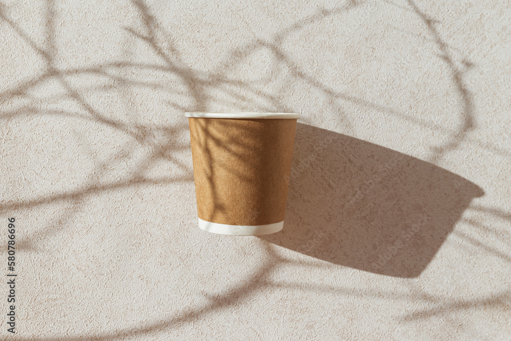 Eco friendly craft paper cup on pastel background with tree branch ...