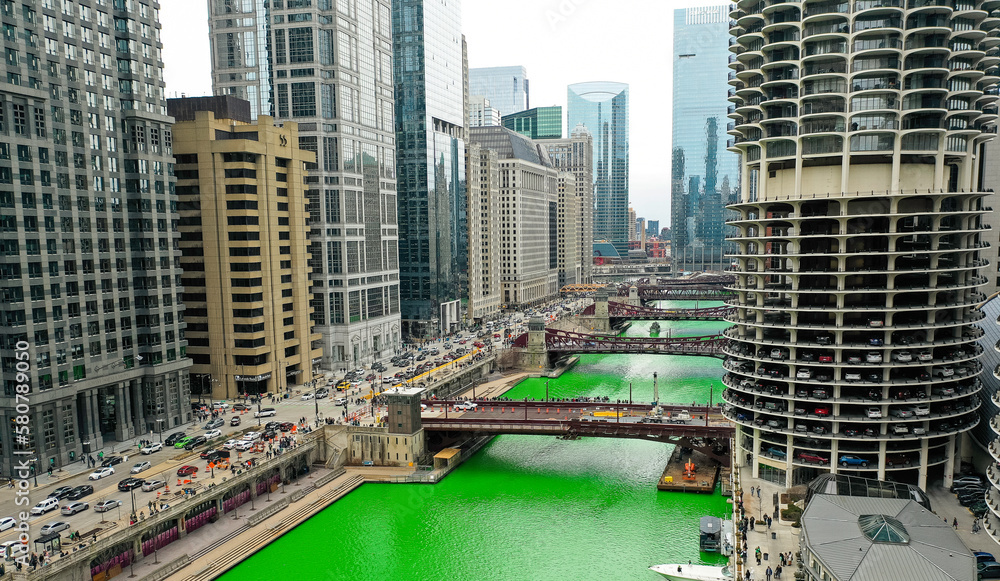Fototapeta premium Aerial view of downtown Chicago, Illinois. Green River for St. Patrick's day celebration. March 2023