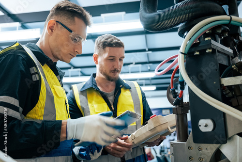 Multiracial tachnicial engineer training with robot arm