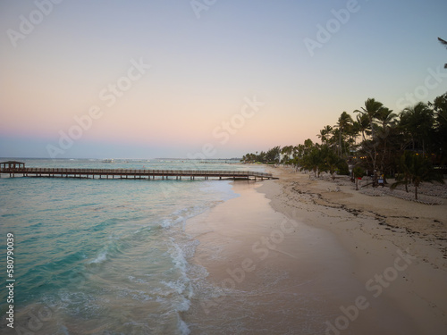 Wallpaper Mural Sandy beach and sea. Lots of palm trees on the beach. Wooden bridge, pier. Twilight. Resort place, romance, solitude, vacation. Torontodigital.ca