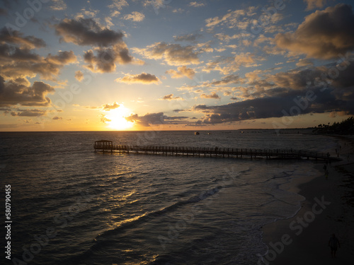 Twilight. Pier on the sea. Dark water. Fluffy clouds in the gray sky  the setting sun. Beauty of nature  calm scenes. Rest  relaxation  solitude.