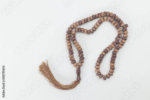 wood beads for keeping count of muslim prayers, Islamic muslim prayer beads on white background