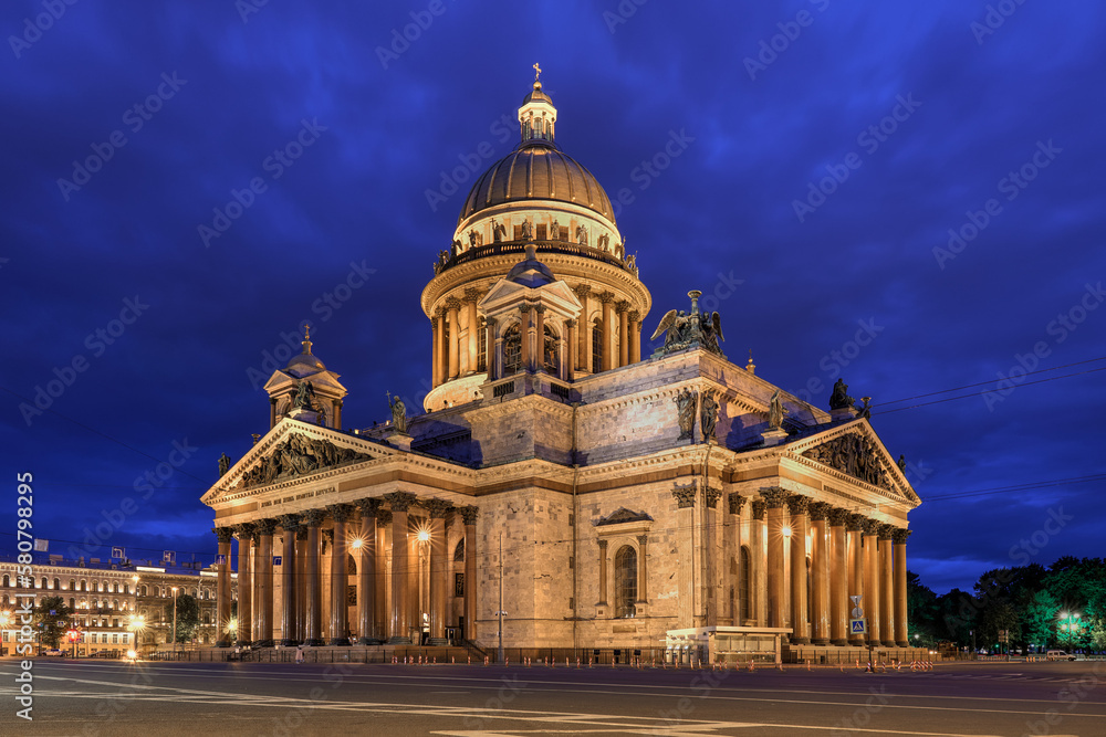 St. Isaac's Cathedral in Saint Petersburg at night. Translation: 'My temple shall be called a temple of prayer' (left), 'In you, O Lord, we hope, that we may not be ashamed forever' (right)