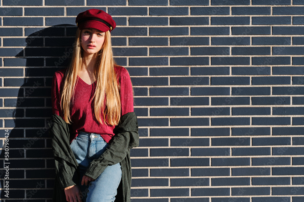 Sensual blonde model posing leaning on an urban wall Sensual blonde model posing leaning on an urban wall