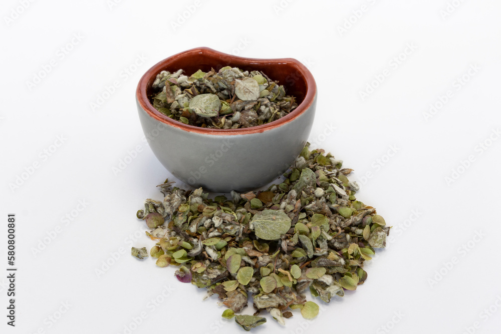 Origanum dictamnus, Dittany of Crete tea in a bowl on a white background. Cretan dittany or hop marjoram is a medicinal tea growing wild only in Crete. It is a healing, therapeutic and aromatic plant Origanum dictamnus, Dittany of Crete tea in a bowl on a white background. Cretan dittany or hop marjoram is a medicinal tea growing wild only in Crete. It is a healing, therapeutic and aromatic plant