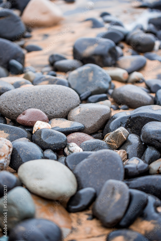view of white sand and black stones on a beach in Sardinia, Costa Verde, Italy view of white sand and black stones on a beach in Sardinia, Costa Verde, Italy