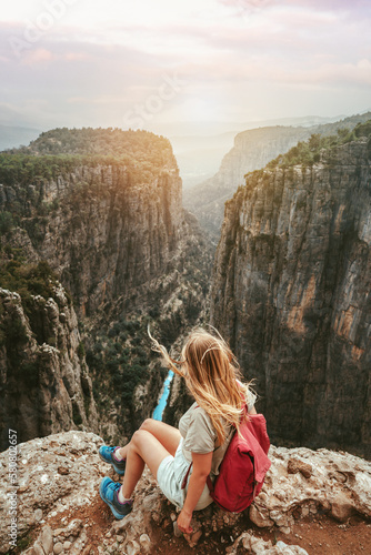 Woman tourist outdoor hiking Tazi canyon in Turkiye travel solo healthy lifestyle eco tourism in mountains girl hiker with backpack on cliff active summer vacations