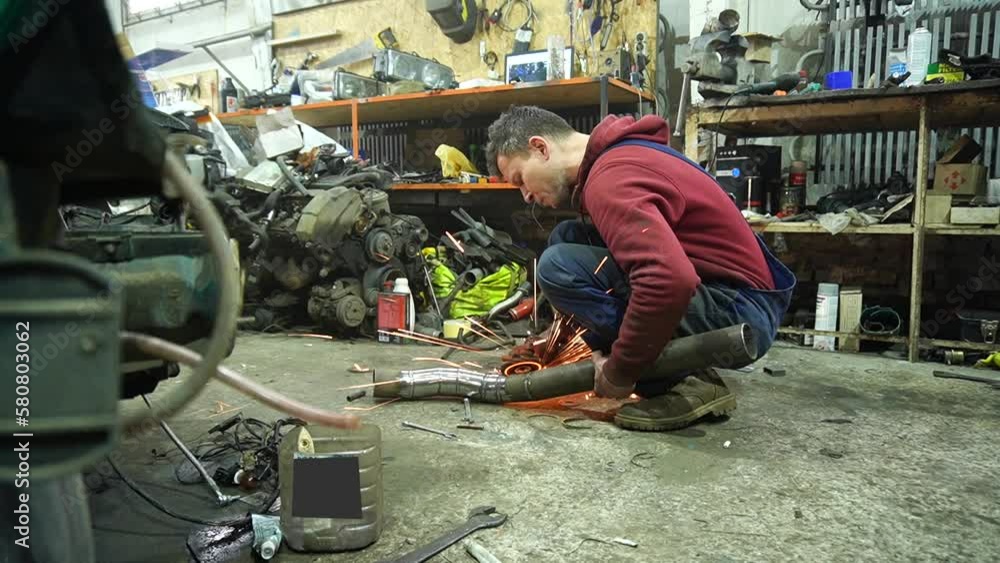 the mechanic performs cleaning work on the custom exhaust manifold and intake system for the turbo engine the mechanic performs cleaning work on the custom exhaust manifold and intake system for the turbo engine