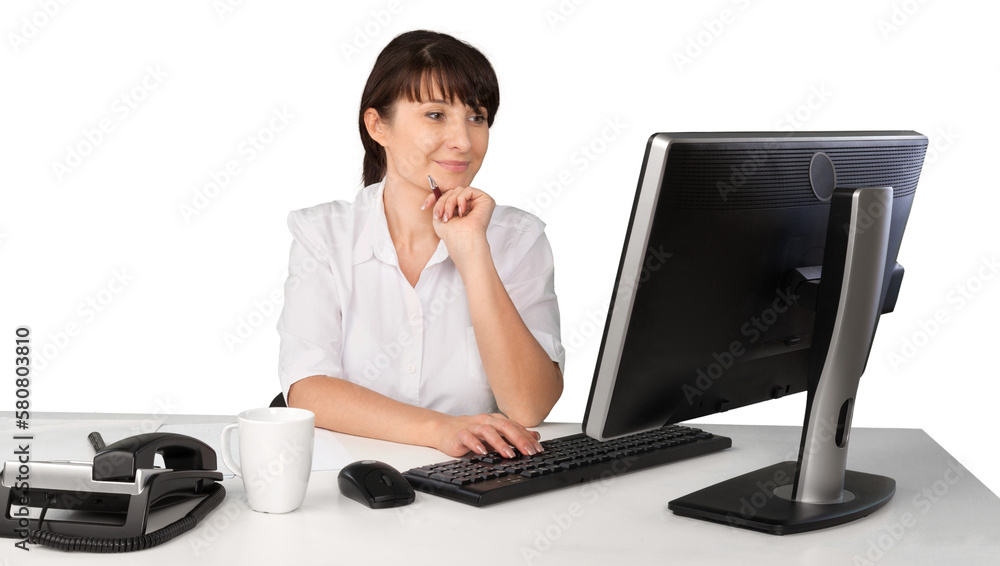 Young businesswoman working at desktop with pc on a white background Young businesswoman working at desktop with pc on a white background