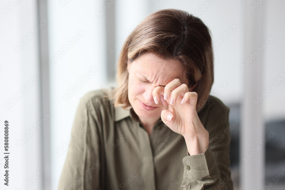 Exhausted, tired female manager sitting with her eyes closed at her desk in office. Exhausted, tired female manager sitting with her eyes closed at her desk in office.
