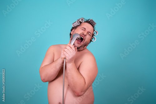 Funny fat man does his hair and washes in the shower.