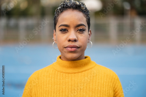 Canvas Print portrait hispanic woman short hair, looking at camera serious