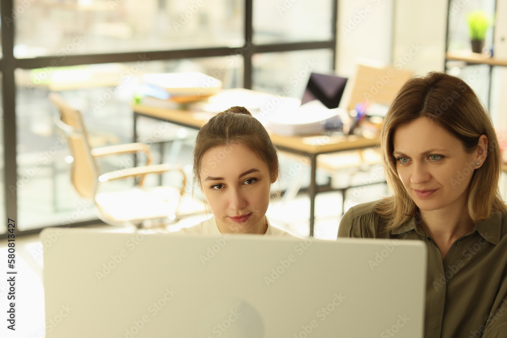 Boss and manager are looking at computer display in office. Boss and manager are looking at computer display in office.