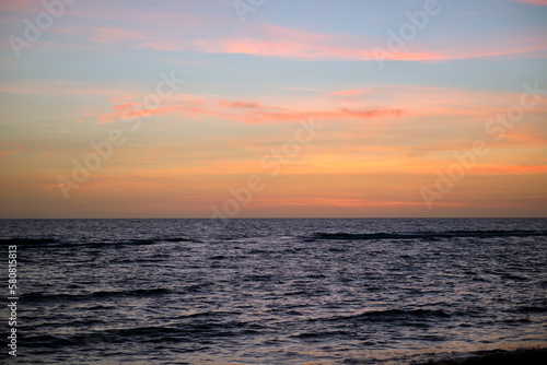 Dramatic red ocean waves at sunset with soft evening sea dark water © bilanol