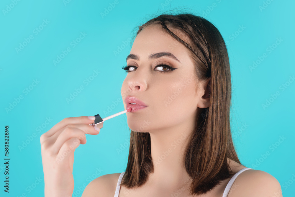 Photo of shirtless woman posing with lipstick, isolated studio background. Beautiful woman holding with naked shoulder hold lipstick. Sexy girl using lipstick. Photo of shirtless woman posing with lipstick, isolated studio background. Beautiful woman holding with naked shoulder hold lipstick. Sexy girl using lipstick.