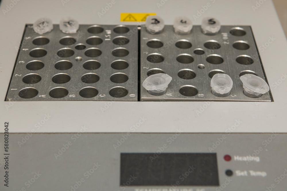 Part of a dry bath with metal heating blocks and a few plastic