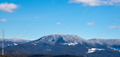 Landscape with the frozen forest on top of the mountains