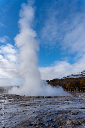 Strokkur geyser in southwestern Iceland. Erupting fountain-type geyser in Haukadalur valley on the slopes of Laugarfjall hill, which is also the home to Geysir geyser.