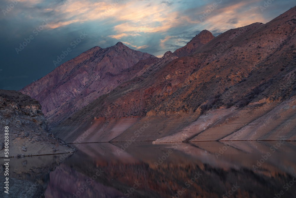 Beautiful sunset over the mountains and lake. Beautiful reflection in the water. 
