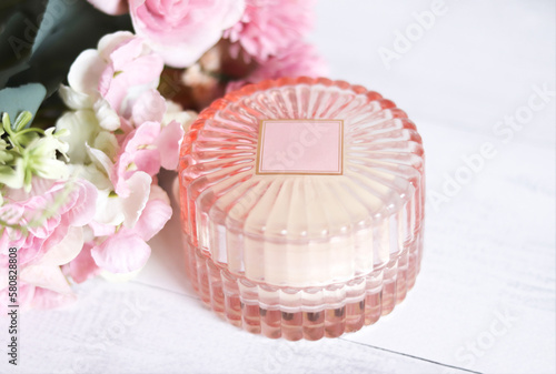 Pink candle decorated with pink flowers. Relaxing set
