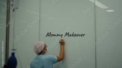 Nurse in the operating room. The nurse is preparing for mommy makeover surgery photo