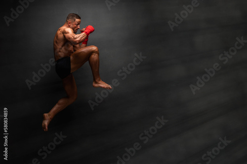 Martial Art Fighter Performing Flying Knee Kick photo