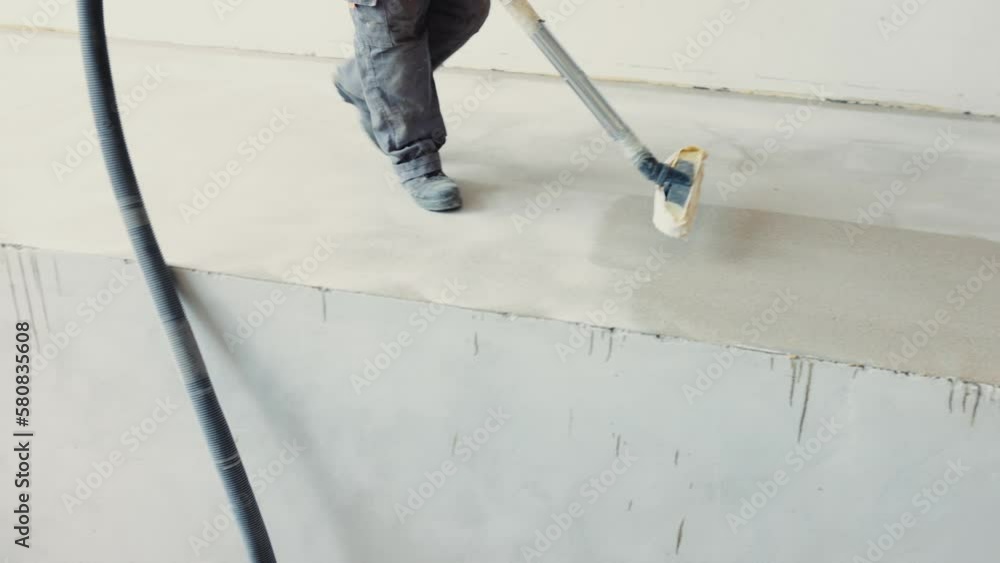 worker vacuum the concrete floor after grinding to remove all of the dust and debris created during the grinding process. worker vacuum the concrete floor after grinding to remove all of the dust and debris created during the grinding process.