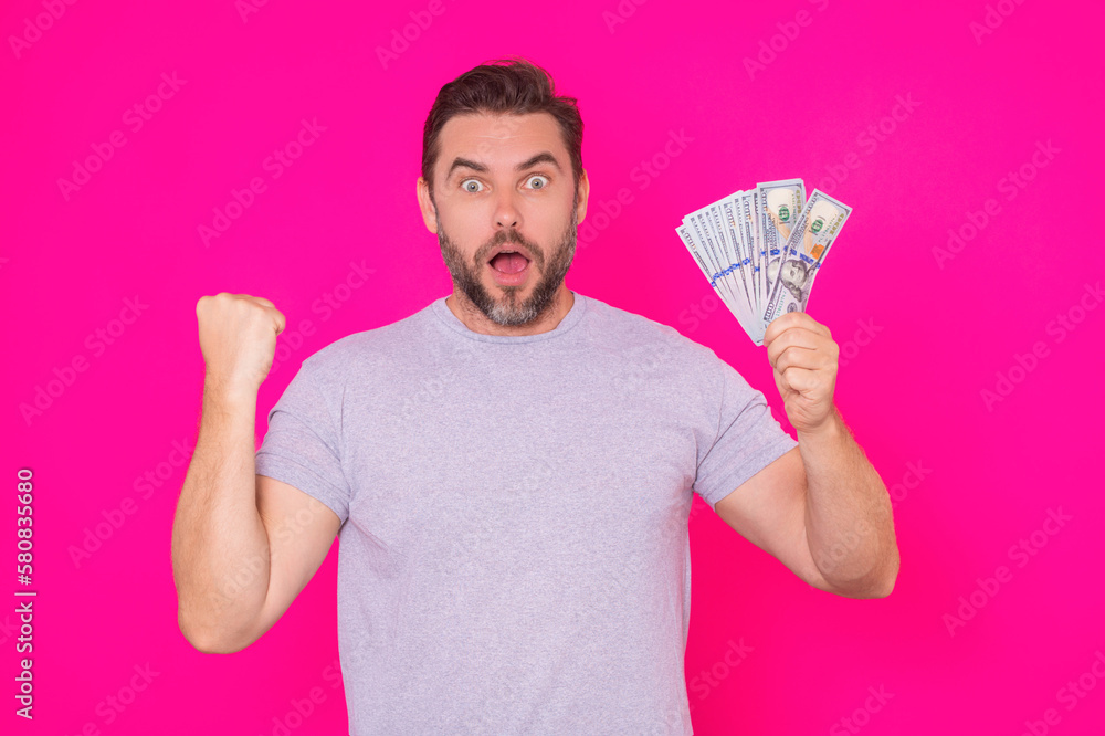 Man with money cash. Dollar banknotes. Portrait of man holding bunch of money banknotes. Dollar bills, credit, online banking. Rich man pointing at dollar banknotes, bank loan, financial savings. Man with money cash. Dollar banknotes. Portrait of man holding bunch of money banknotes. Dollar bills, credit, online banking. Rich man pointing at dollar banknotes, bank loan, financial savings.