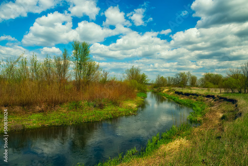 Spring country landscape with a small river.