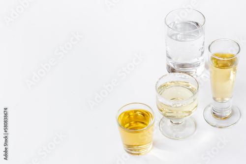 Alcohol in glasses with ice. Strong alcoholic drinks background