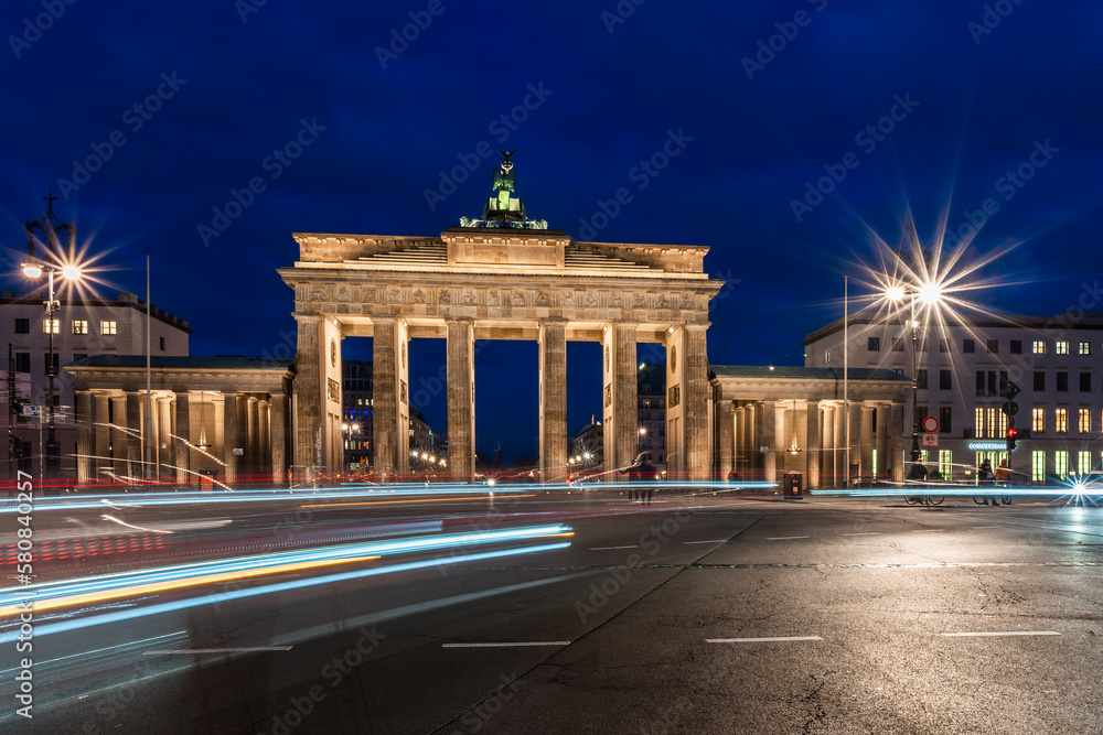 Traces of light in front of the Brandenburg Gate in Berlin at the blue hour
