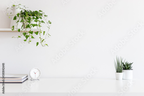 Desk at home office with supplies and wall copy space. Minimalistic workspace.	