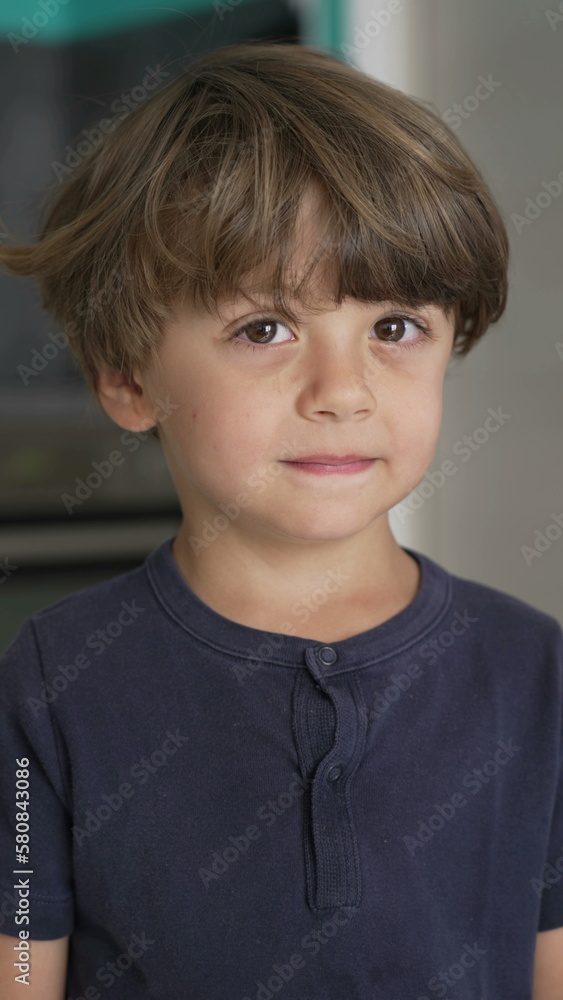 Portrait of a pensive child close up face. A thoughtful expression of one small boy in Vertical Video Portrait of a pensive child close up face. A thoughtful expression of one small boy in Vertical Video