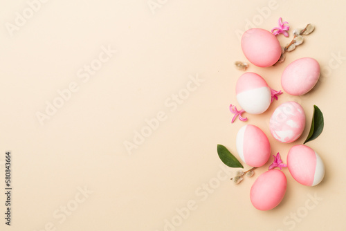 Pink Easter eggs with decor on color background  top view