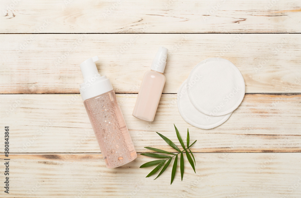Face care products with eco pads on wooden background, top view Face care products with eco pads on wooden background, top view
