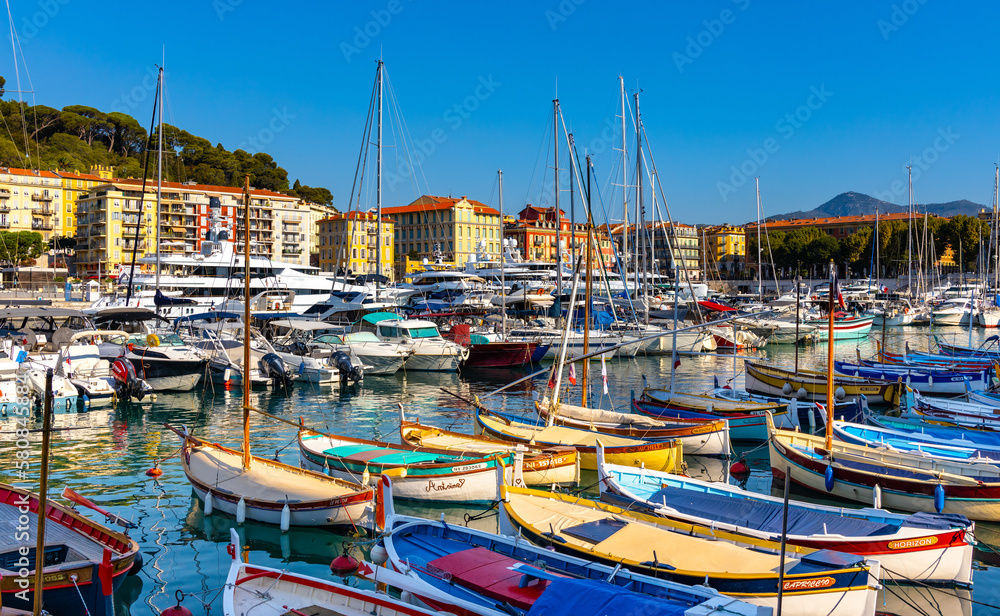 Nice port with yachts, boats and pierces in Nice Port and yacht marina district with Colline du Chateau Castle hill on French Riviera in France