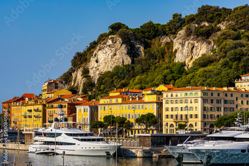 Nice port with yachts, boats and pierces in Nice Port and yacht marina district with Colline du Chateau Castle hill on French Riviera in France